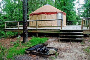 Yurt,Camp,Site,Built,On,A,Deck,With,In-ground,Fire