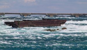 The,Rusting,Niagara,Scow,Above,The,Falls,,Surrounded,By,Rapids,