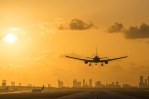 Airplane,Landing,At,Miami,International,Airport,At,Sunrise,With,Miami