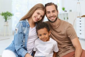 Happy,Couple,With,Adopted,African-american,Boy,At,Home